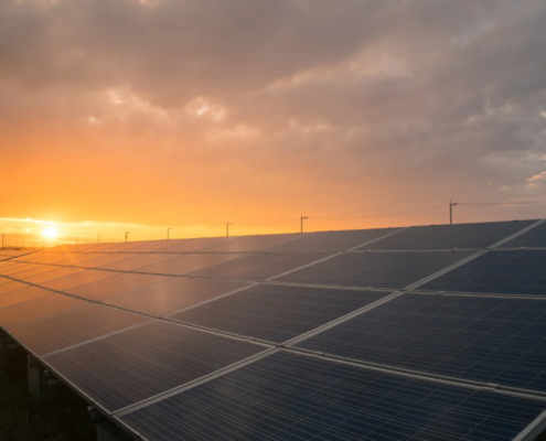 Painéis solares captando energia durante o pôr do sol em campo aberto
